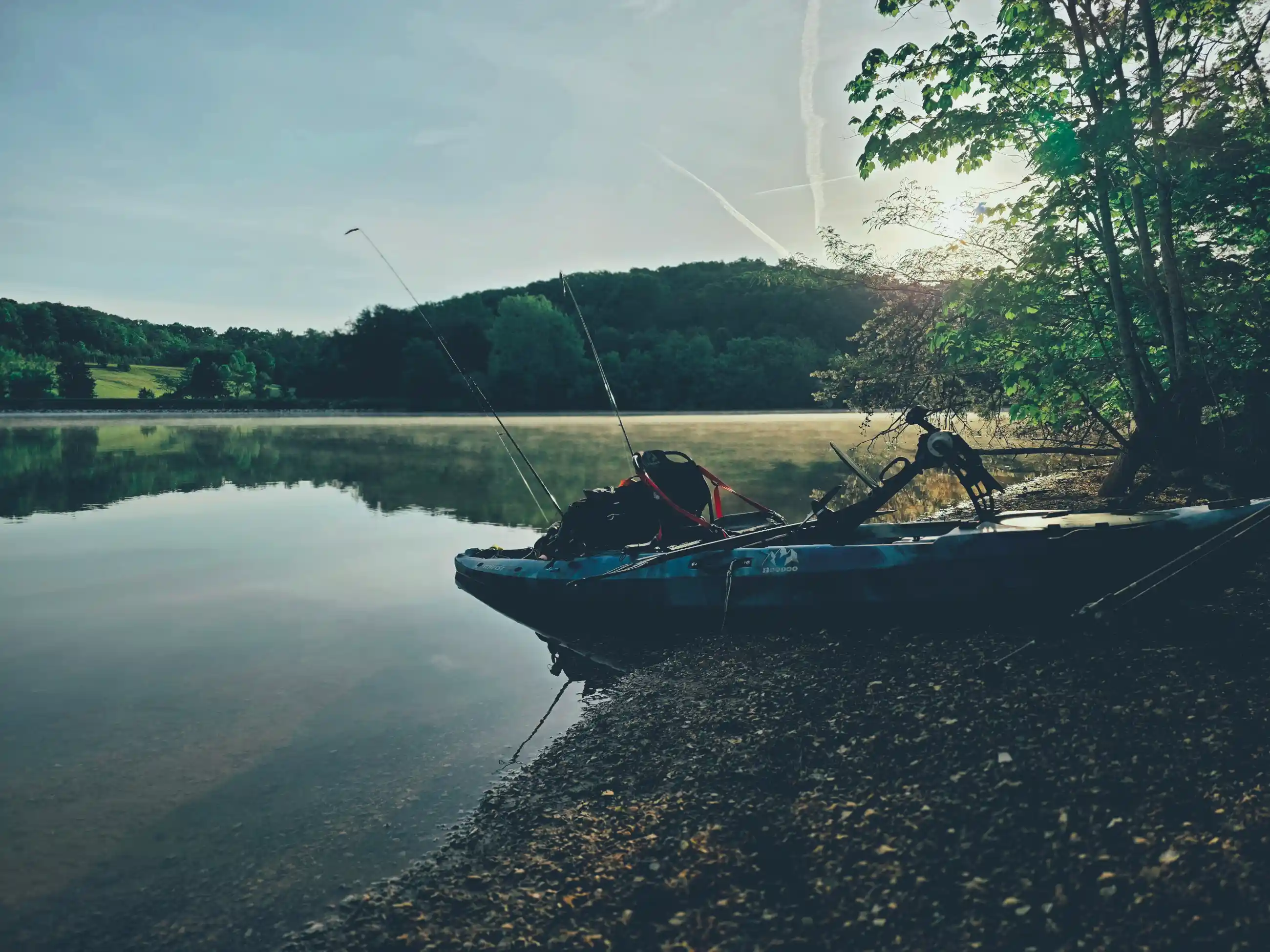 Angler fishing from a kayak at first light